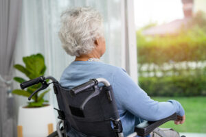 An Elderly Woman Sitting On Wheelchair Looking Outsidea